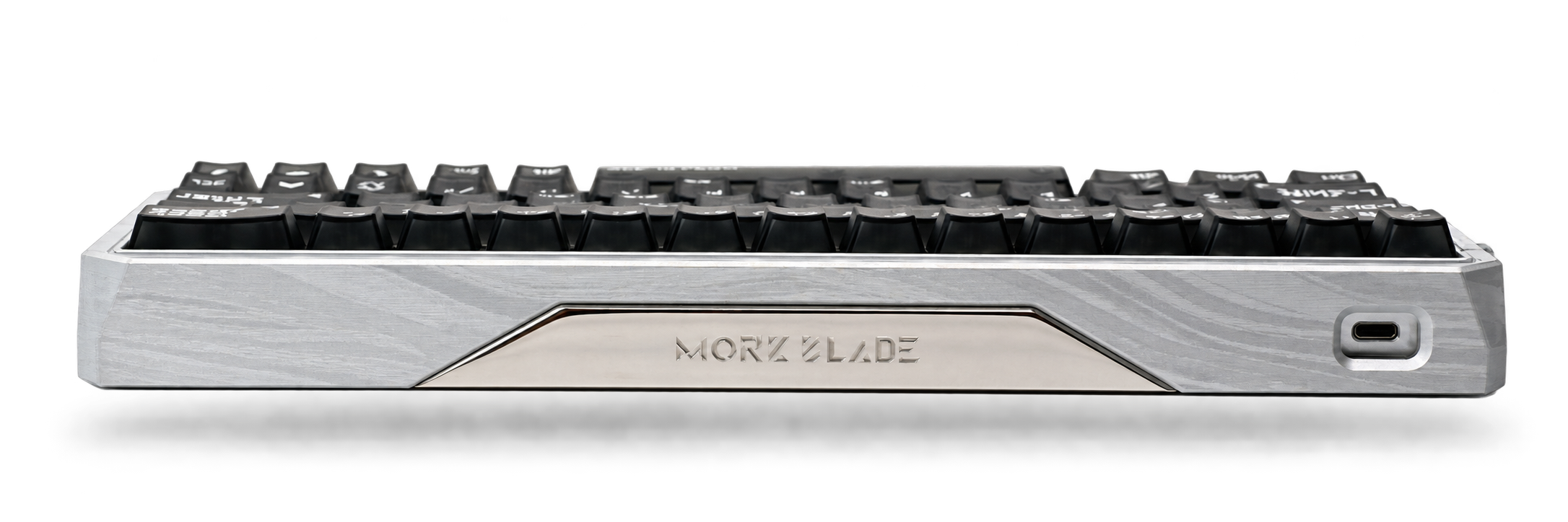 Low-angle view of the silver-patterned Morkblade GH60 case with black keycaps, appearing to float above a soft shadow. Case-only preorder.