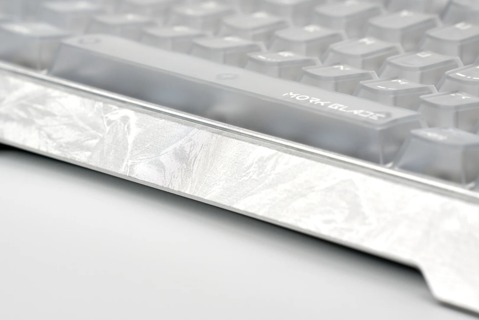 Close-up of the new patterned silver finish along the front edge of the GH60 case.